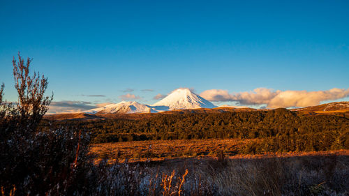 Panoramic view of volcanic landscape against blue sky