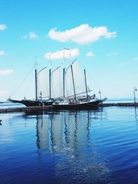 Sailboats in sea against sky