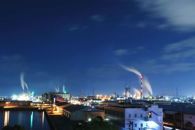 Illuminated harbor against sky at night