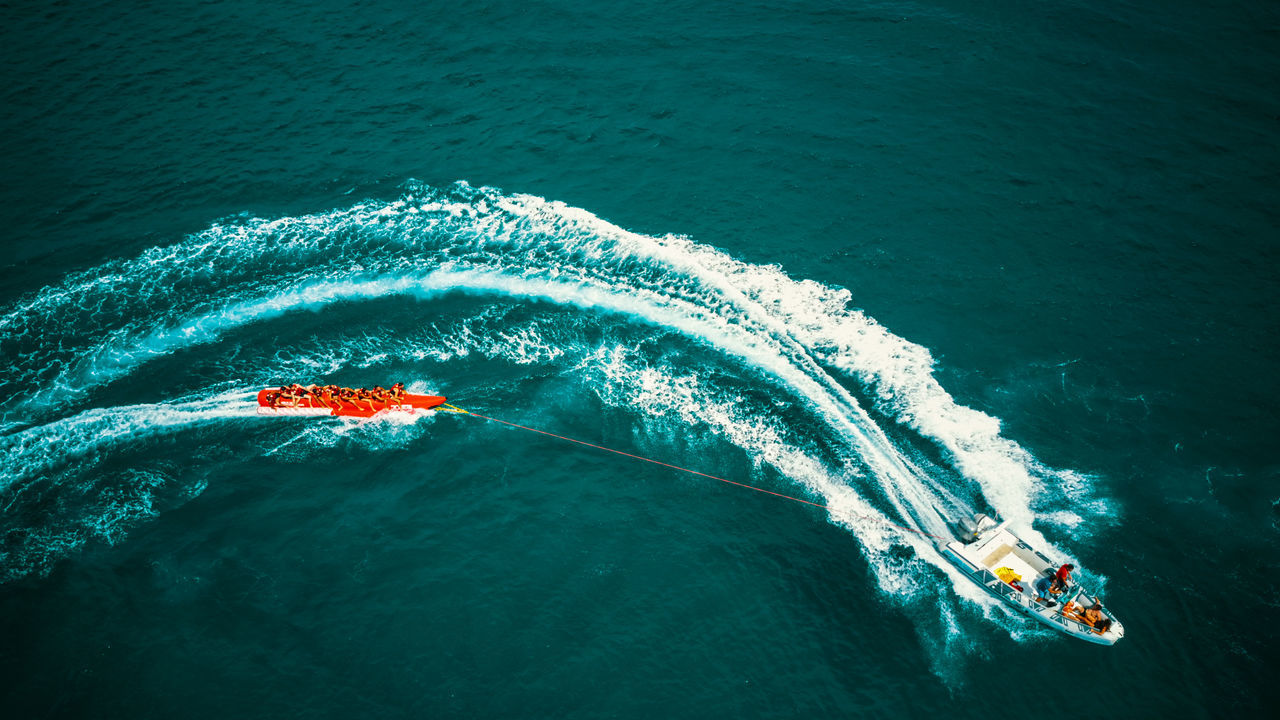 HIGH ANGLE VIEW OF PEOPLE IN SEA