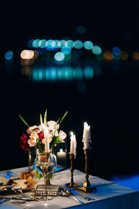 Close-up of illuminated flower vase on table