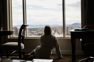 Woman looking through window