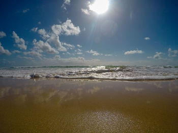 Scenic view of sea against sky on sunny day