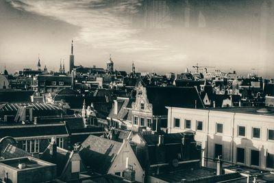 Cityscape against cloudy sky