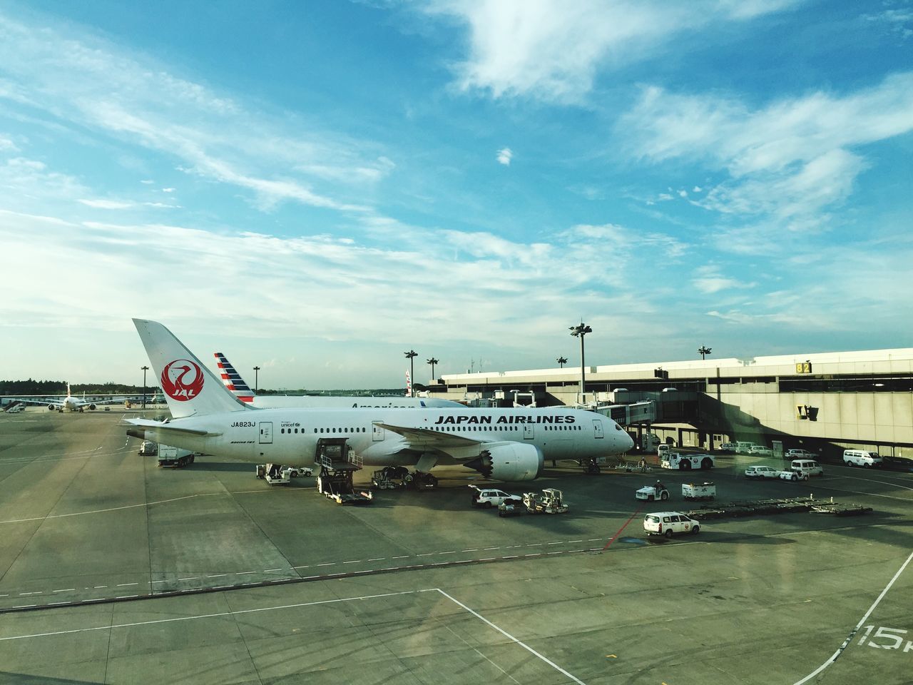 transportation, mode of transport, air vehicle, sky, airplane, land vehicle, travel, cloud - sky, public transportation, flying, car, on the move, built structure, road, architecture, airport runway, journey, road marking, airport, day