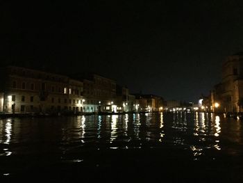 Reflection of illuminated buildings in water at night