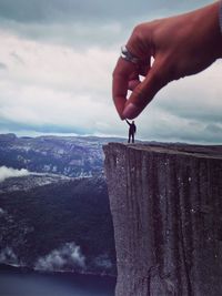 Close-up of woman against cloudy sky