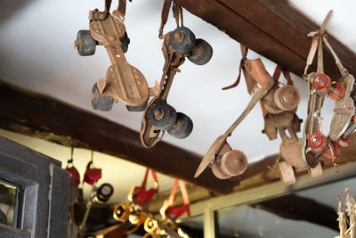 Close-up of roller skate hanging on ceiling