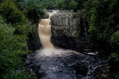 Water flowing through rocks in forest