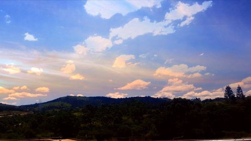 Scenic view of mountains against cloudy sky