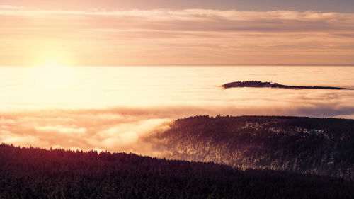 Scenic view of land against sky during sunset