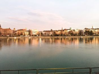 River by buildings against sky in city