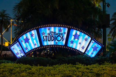 Low angle view of information sign at night