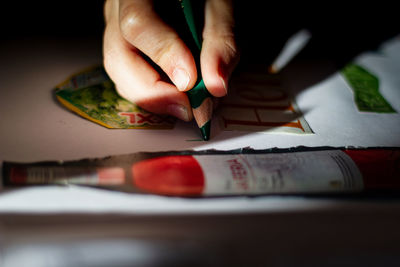 Close-up of hand holding paper