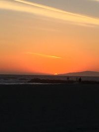 Scenic view of beach against sky during sunset