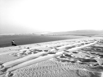Scenic view of snow covered landscape against clear sky