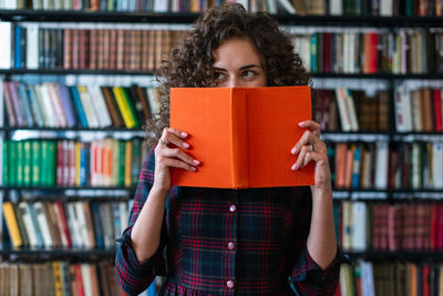 Portrait of teenage girl in book