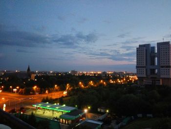 View of cityscape against cloudy sky