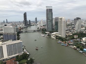 High angle view of river amidst buildings against sky