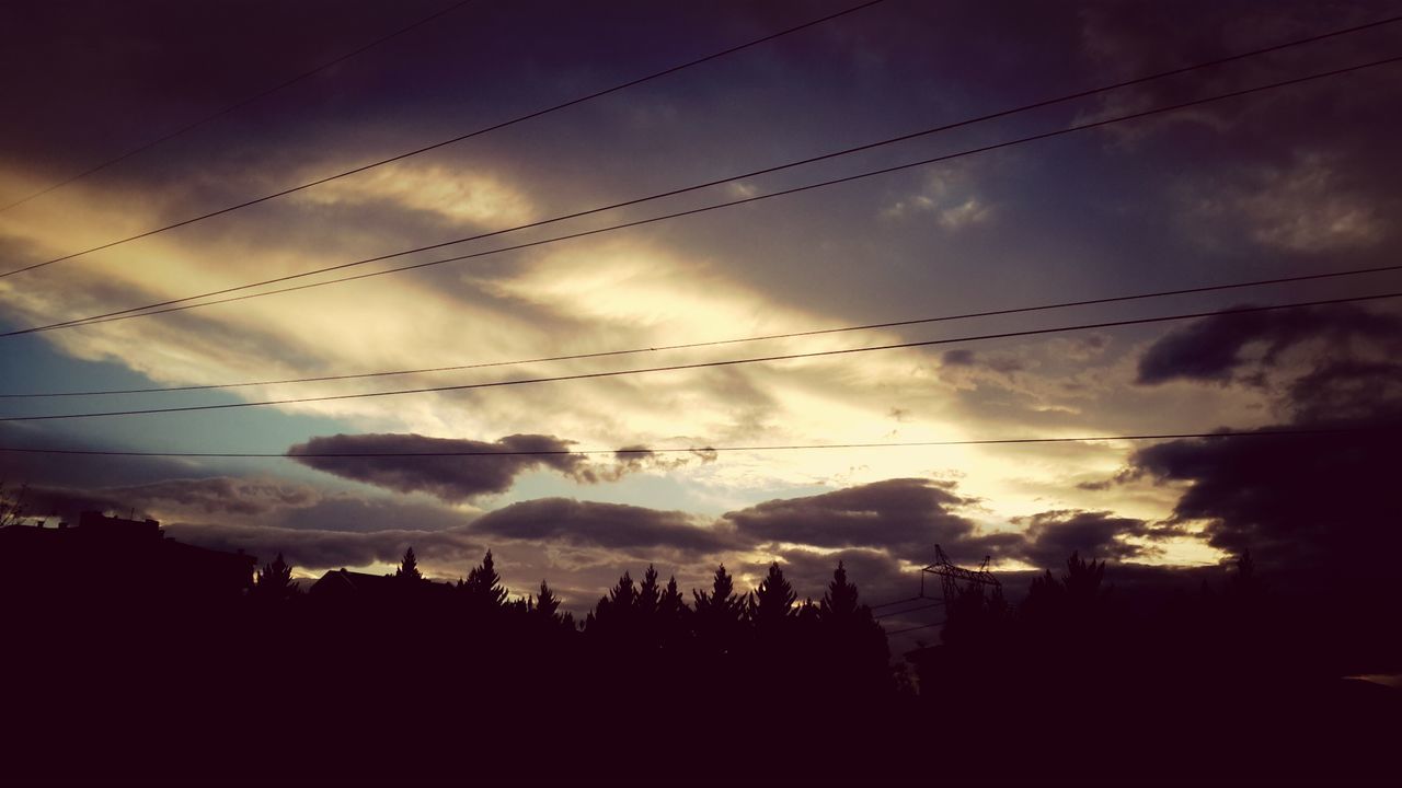 sky, silhouette, cloud - sky, power line, cloudy, low angle view, dusk, weather, cloud, sunset, electricity pylon, scenics, nature, beauty in nature, electricity, cable, tranquility, tranquil scene, landscape, tree