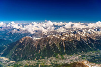 Scenic view of snowcapped mountains against blue sky