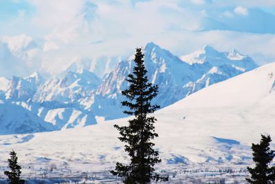 Scenic view of snow covered mountains against sky