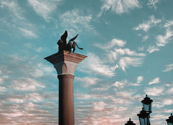 Low angle view of statue against cloudy sky