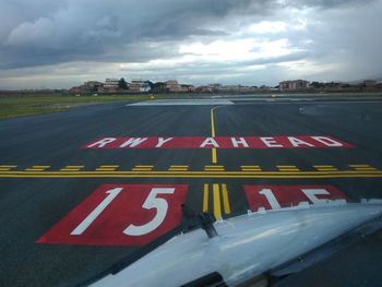 High angle view of text on road against sky