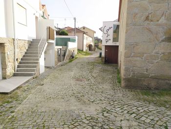 Empty alley amidst buildings