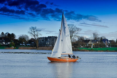 Sailboat sailing in sea against sky