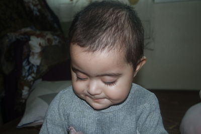 Close-up portrait of cute boy at home