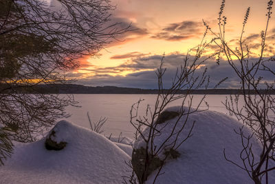 Scenic view of lake against sky during winter