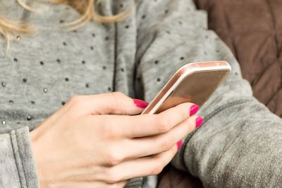 Midsection of woman using smart phone