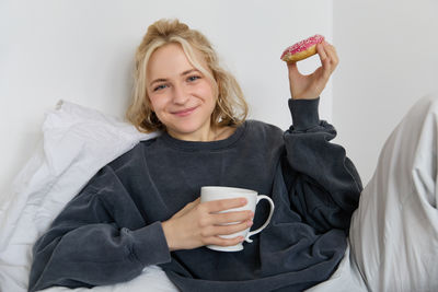 Portrait of young woman using mobile phone