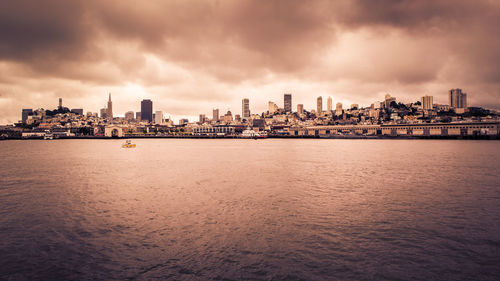 Scenic view of sea and buildings against sky