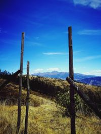 Wooden fence on field against sky