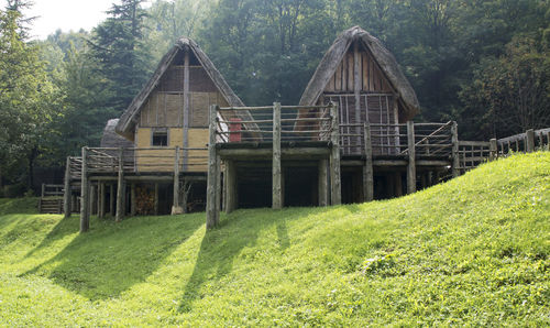 View of wooden house on field