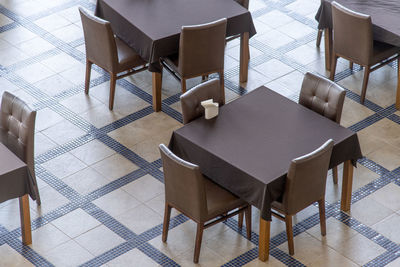 High angle view of chairs on table