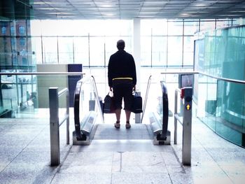 Rear view of woman walking in corridor