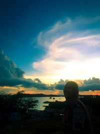 Rear view of woman looking at sunset