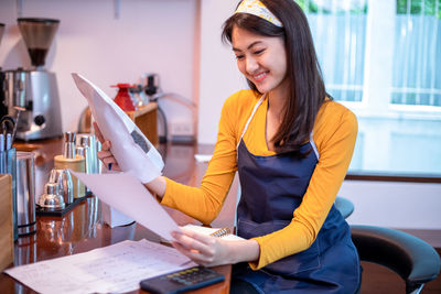 Portrait of young woman working at home