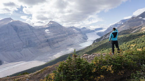 Rear view of man walking on mountain