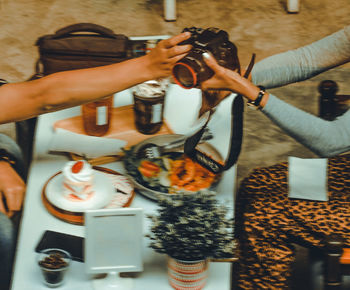 High angle view of people photographing food