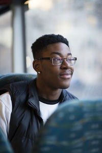 Smiling man in bus looking away