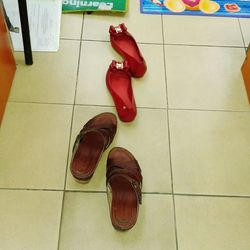 Low section of woman relaxing on tiled floor