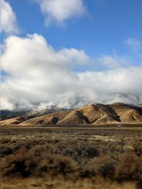 Scenic view of arid landscape against sky