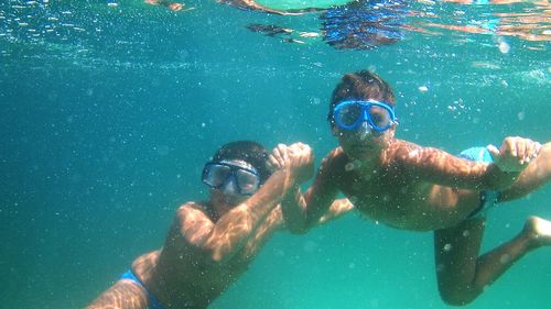 Young man swimming in sea