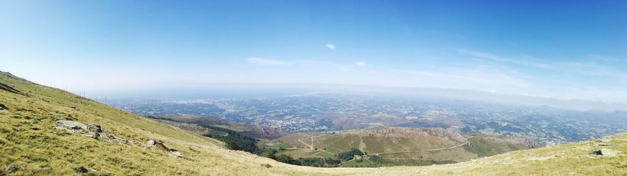 Scenic view of mountains against blue sky