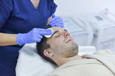 Midsection of man lying on blanket