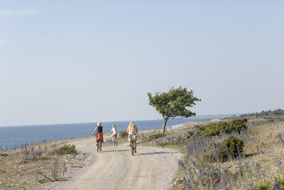 Mother with two daughters cycling